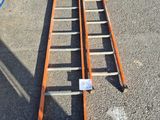 a ladder that is laying on the ground in front of a building