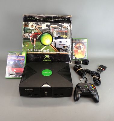 a video game console and a game controller on a table