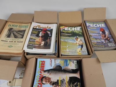 several magazines are in a cardboard box on a white surface