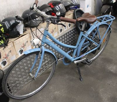 a blue bicycle parked next to a pile of boxes