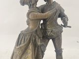 a statue of a man and a woman that are standing next to each other