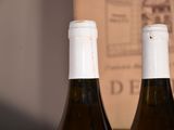 two bottles of wine that are sitting on a table