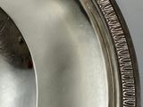 a close up of a silver plate on a table