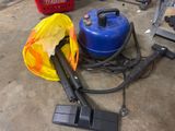 two vacuums and a yellow bag on the floor