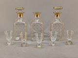 four glass decanters and a decanter on a table