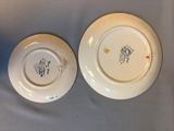 two plates with designs on them are sitting on a table