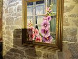 a picture of a painting hanging on the wall of a bathroom