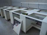 a white workbench in the middle of a room with a magazine on it