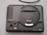 a game console with a game controller on top of it