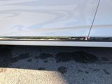 a close up of a car ' s door handle on the side of the road