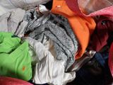 a pile of clothes in a bag on the floor