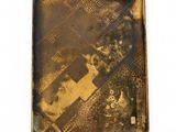 a metal tray that has a gold design on it