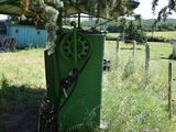 a green machine that is sitting in the grass
