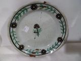 a plate with a clock on it sitting on a table