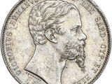 une pièce d'argent à l'effigie d'un homme barbu