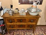 a dresser with a bowl on top of it and a vase on top of it