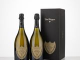 two bottles of champagne in front of a black box