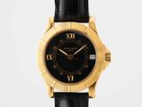 a close up of a black and gold wrist watch with roman numerals