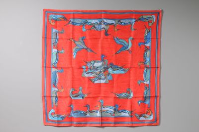 a red and blue scarf hanging on a wall