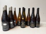 several bottles of wine are lined up in a row on a table