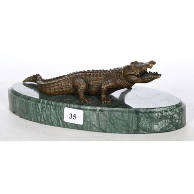 an image of a statue of a crocodile on a marble base