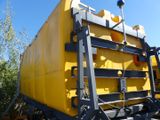 a large yellow tank sitting on the back of a truck