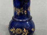 a blue vase with a gold design on it