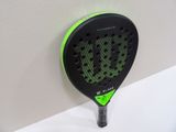 a close up of a tennis racket on a wall