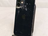 an iphone with a broken screen sitting on top of a table