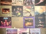 various albums and cds are arranged on a carpeted floor
