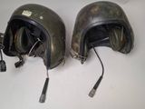 two helmets that are sitting on a table