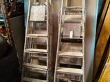 two ladders sitting next to each other in a room