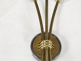 brass plated wall sconce with three glass flowers on it