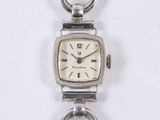 an image of a close up of a wrist watch on a chain