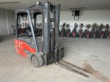 a forklift in a warehouse with a lot of other forklifts in the background