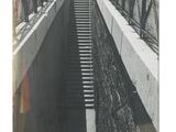 a black and white photo of a bridge with stairs