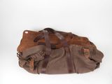 duffel bag on white background with brown leather straps