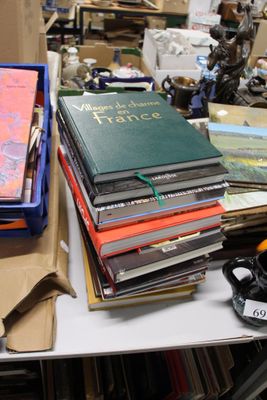 a pile of books sitting on a table next to a pair of scissors