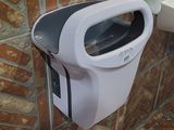 a toilet and a trash can in a bathroom