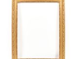 a gold frame on a white wall with a white background