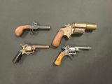 three revolvers and two revolvers on a table