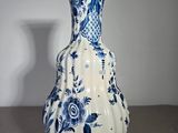 a blue and white vase sitting on a table