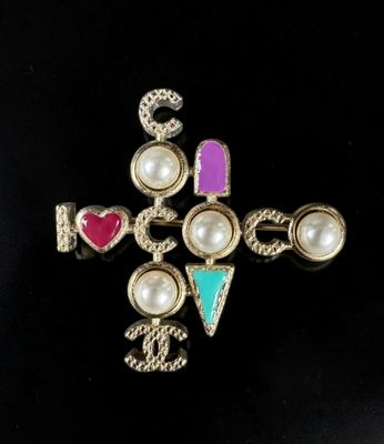 an image of a cross with pearls and jewels