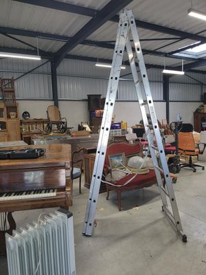 a large room with a ladder and a piano in it
