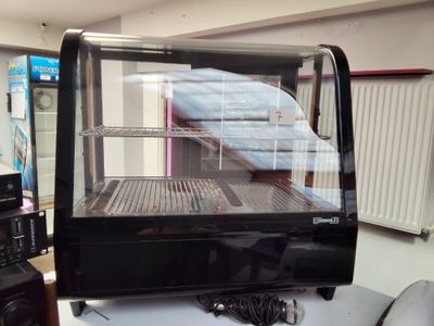 une vitrine en verre contenant des aliments, posée sur une table