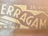 brown leather wallet with a logo on the inside of it