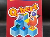 the box for the video game q - bert is sitting on the table