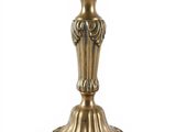 brass candle holder with ornate design on base