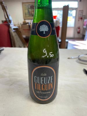 a bottle of beer sitting on a table in a restaurant