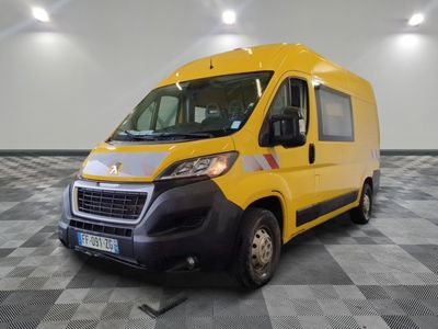 the yellow van is parked on a checkered floor in the garage